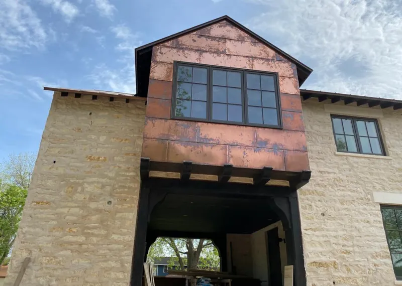 Copper metal panel facade on a stone building for Metal Roof Coating in Belle Fourche